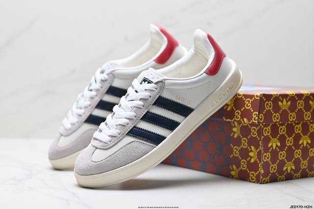 A major corporate collaboration between Adidas and Gucci. The Trefoil logo and t