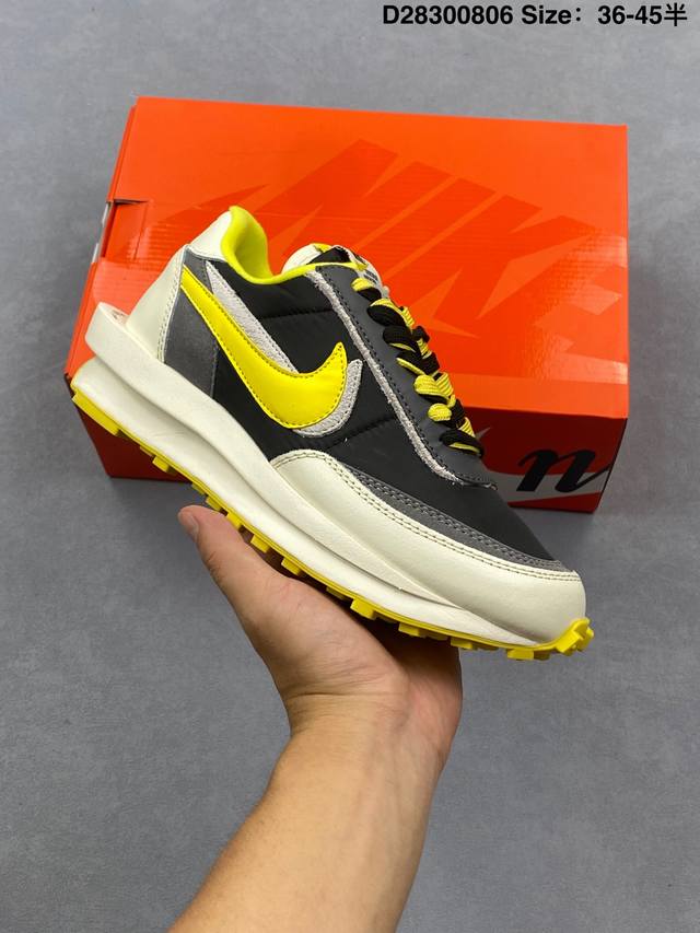 The Sacai XN Ldwaffle "Midnight Spruce and University Red" collaboration feature