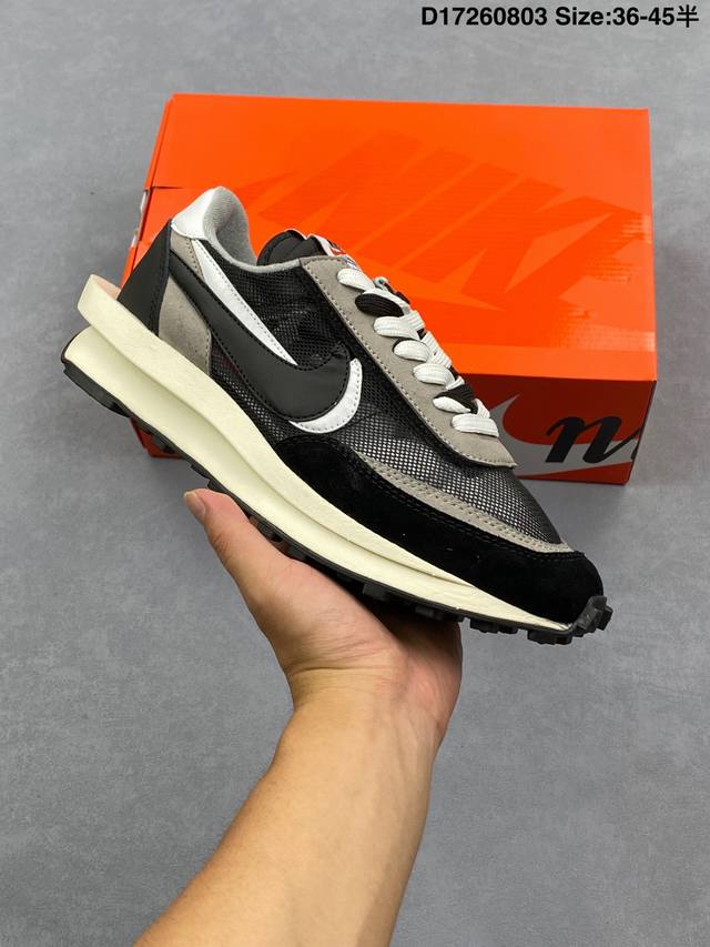 The Sacai XN Ldwaffle "Midnight Spruce and University Red" Waffle 2.0 features a