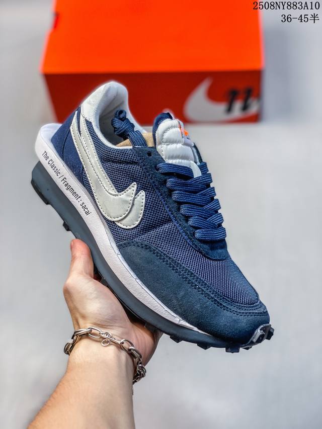 The Sacai XN Ldwaffle "Midnight Spruce and University Red" Waffle 2.0 features a