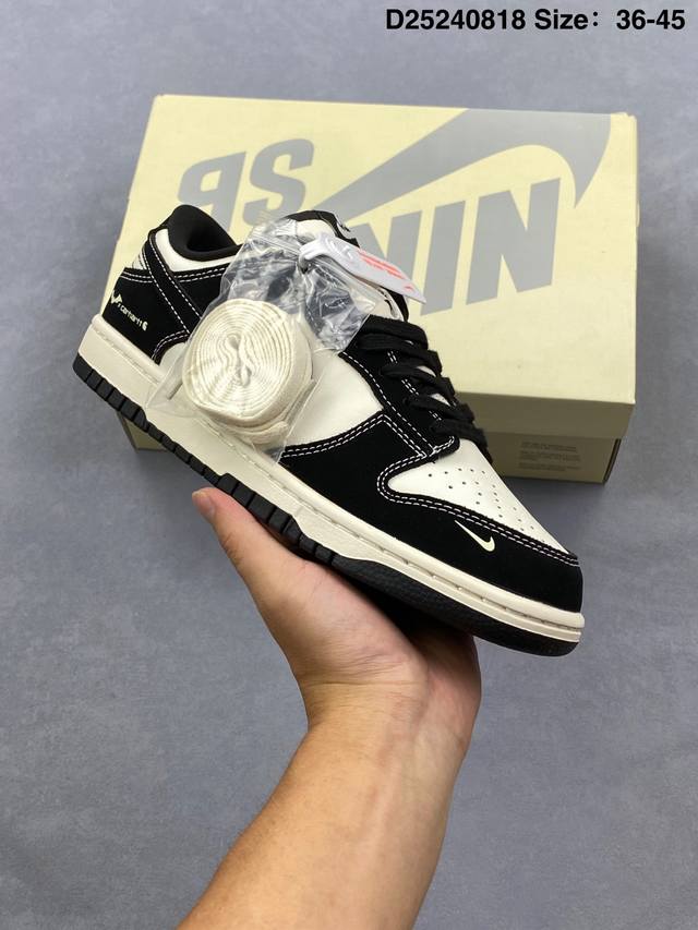 The Stussy x Nike Dunk Sb Low collaboration features an off-white and grey upper