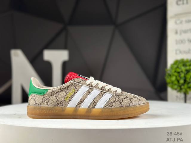 The Adidas X Gucci collaboration features the Trefoil logo and iconic three-stri