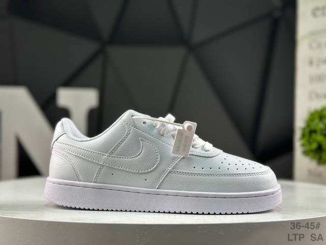 Nike Court Vision Lo Low-Top Sneakers feature a white, blue, and yellow upper.